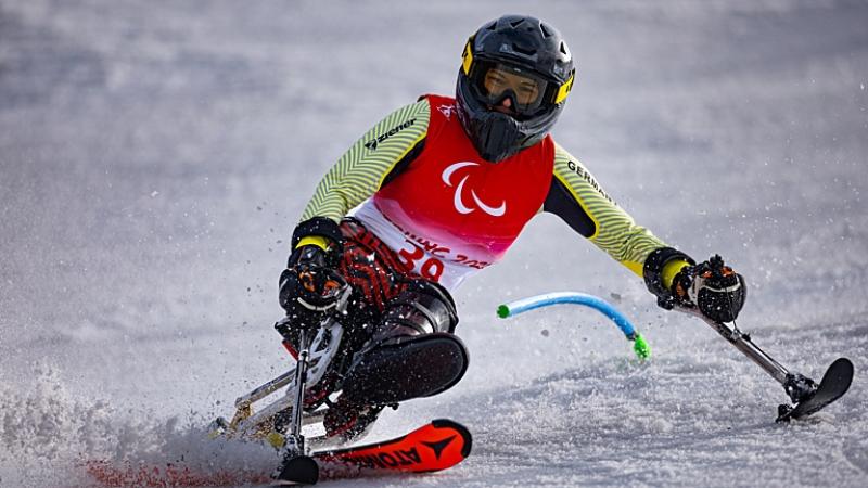 A female sit-skiing athlete in action