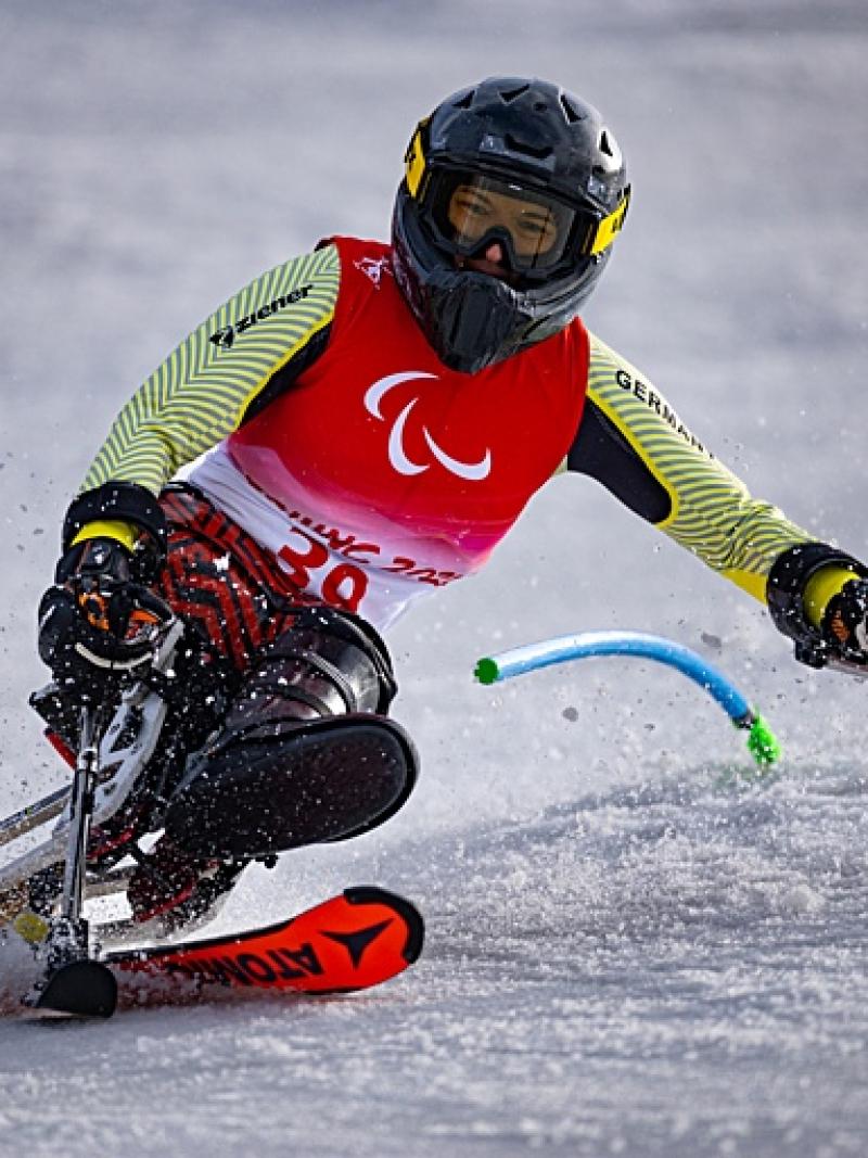 A female sit-skiing athlete in action