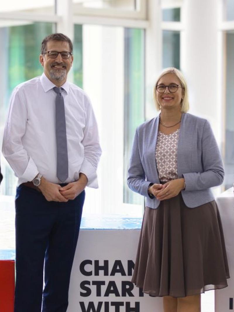Seven people, including State Minister for Sport and Volunteering, pose for a photograph at the IPC Campus