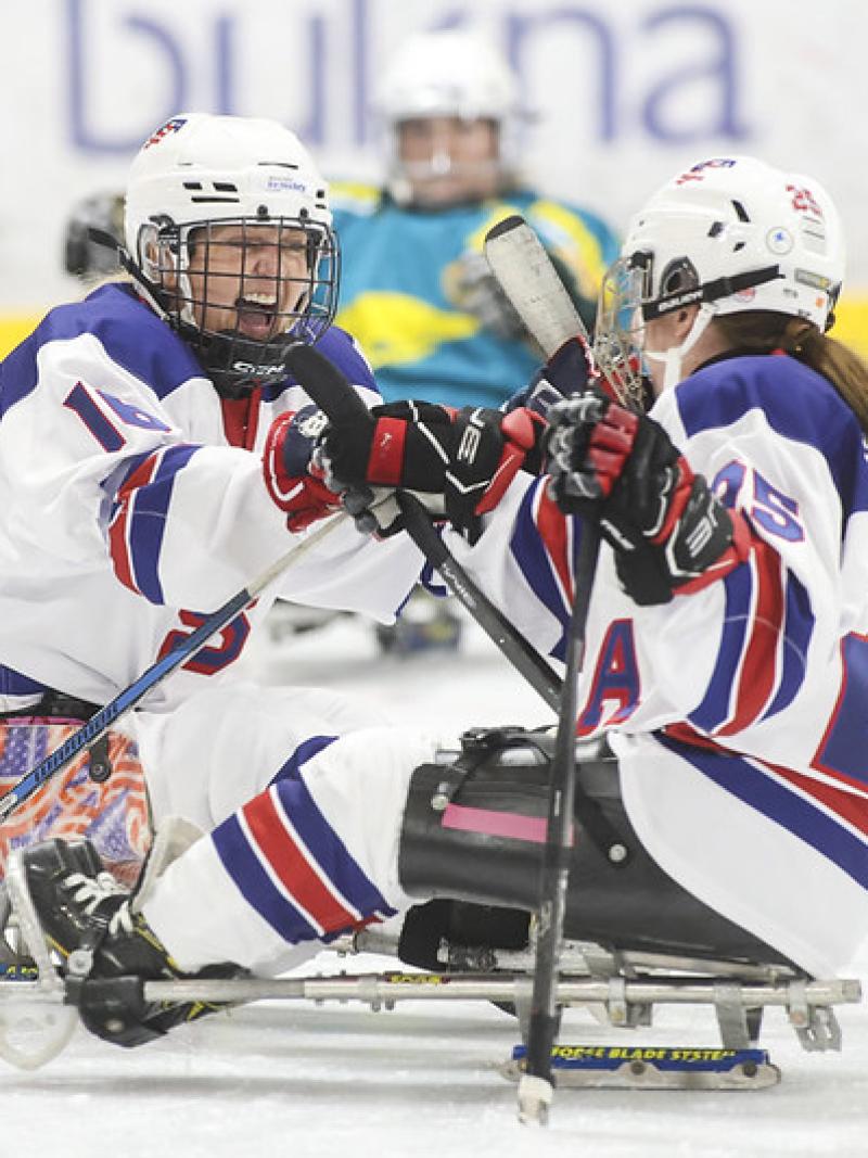 Monica Quimby of the United States celebrates with her teammate in Para ice hockey at a women's tournament