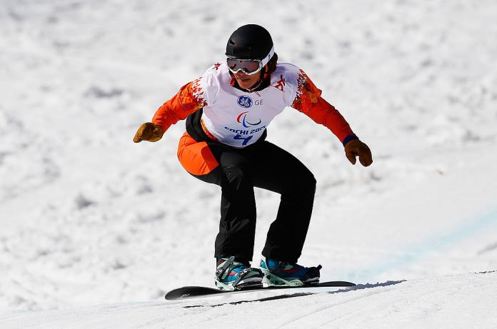 A female Para snowboarding athlete in action