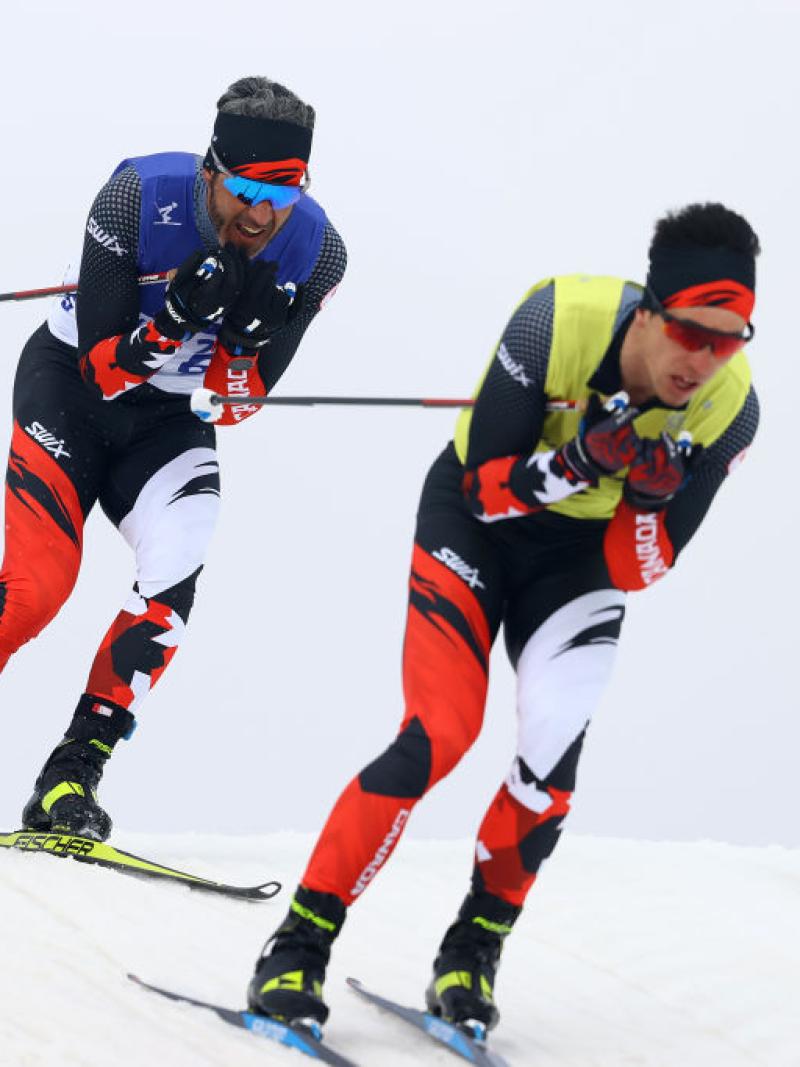 Two male Para cross-country skiing athletes in action