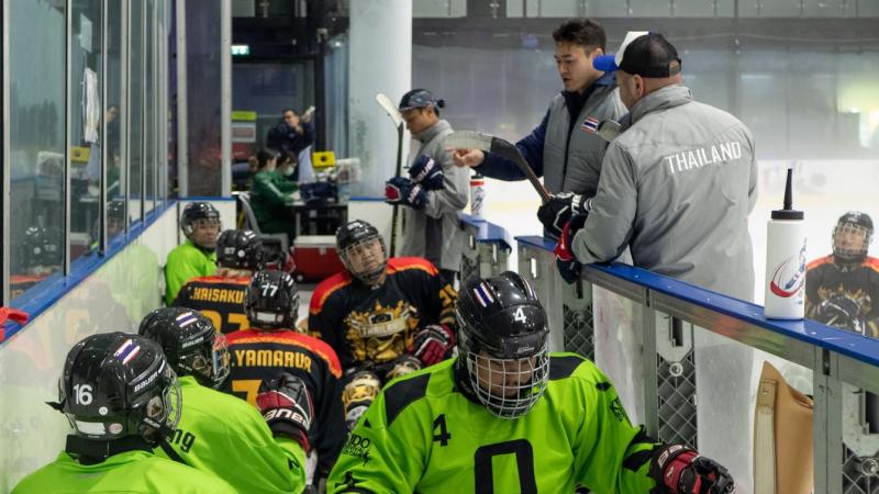 Players enter the ice hockey rink