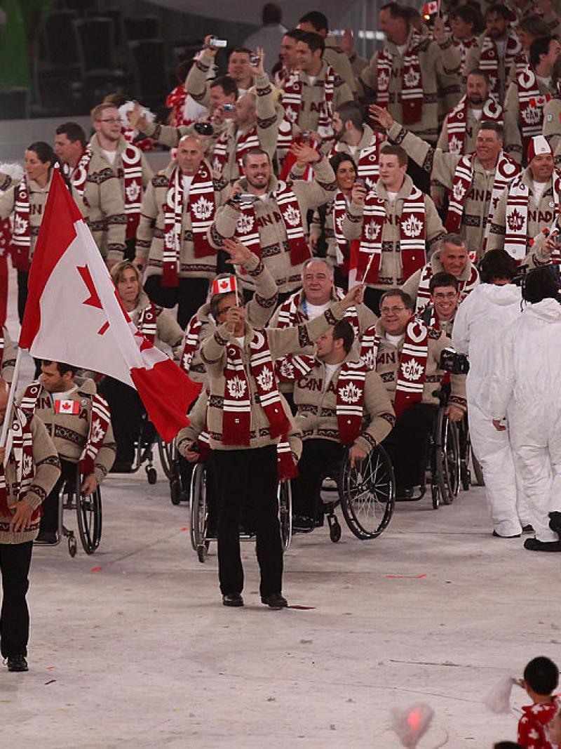 Flag bearer Jean Labonte of Canada leads his team through the stadium during the Opening Ceremony of the 2010 Vancouver Paralympic Winter Games. 