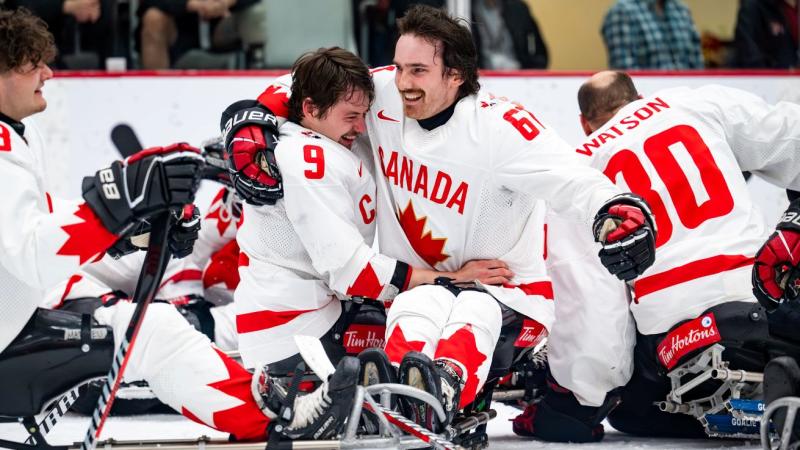 Two Para ice hockey players celebrate on ice after winning the Calgary 2024 World Para Ice Hockey Championships
