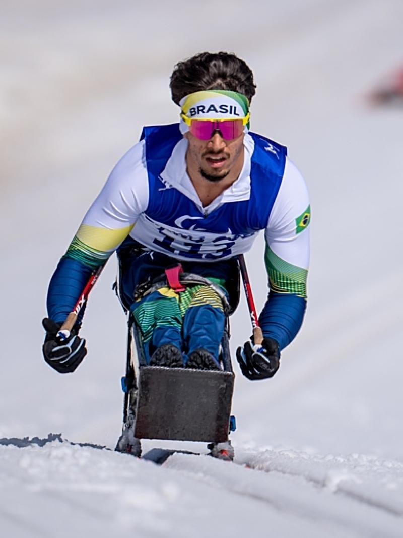 A male Paralympic sit-skier competes in Para cross-country skiing during Beijing 2022