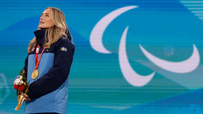 A female Para athlete with a gold medal around her neck