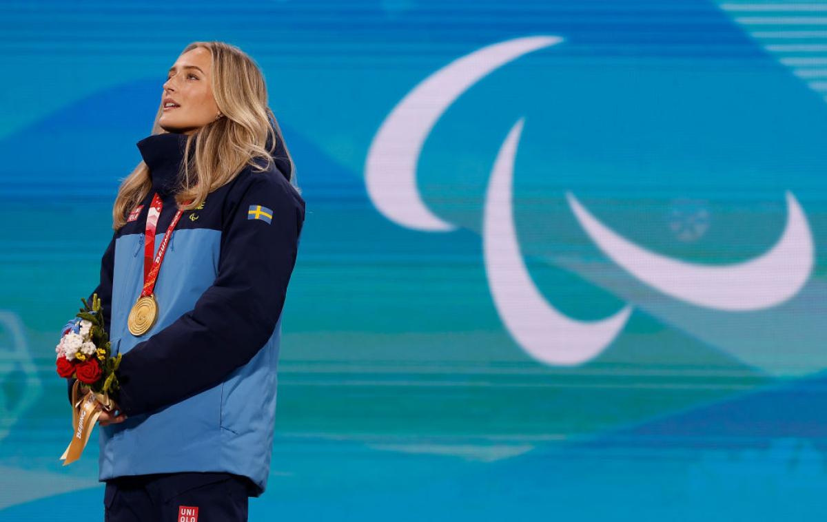 A female Para athlete with a gold medal around her neck