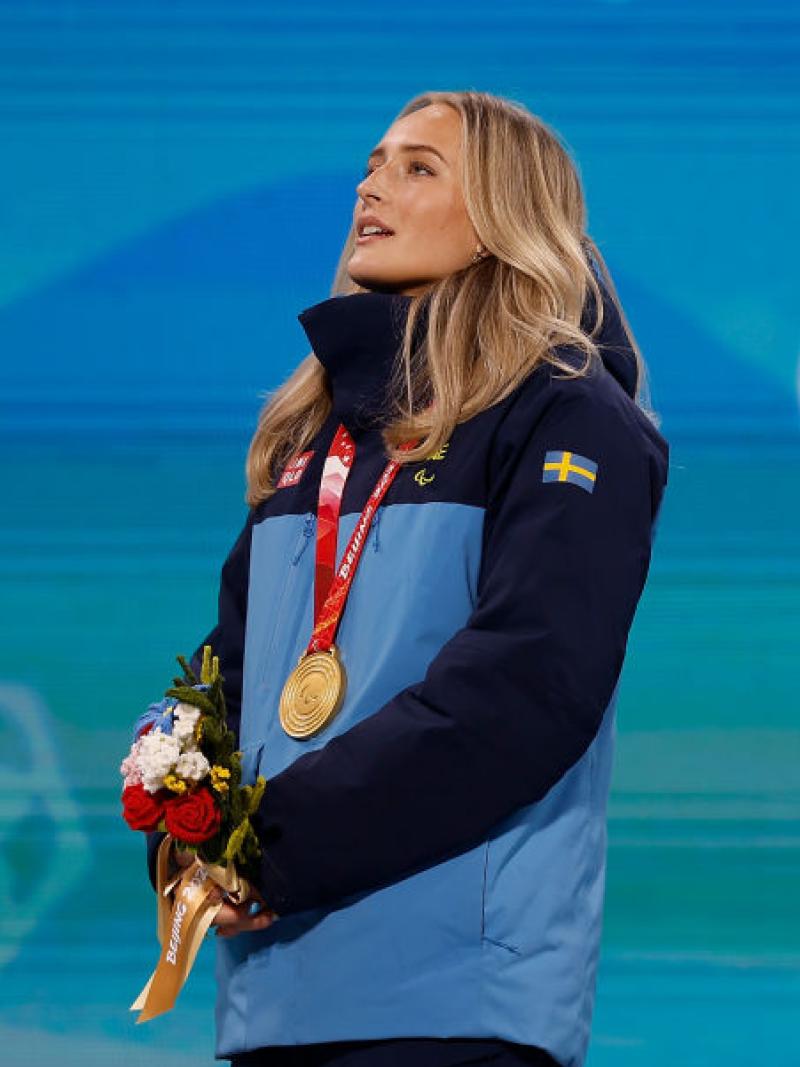 A female Para athlete with a gold medal around her neck