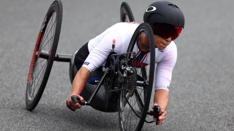 A woman races in a handcycle at Tokyo 2020
