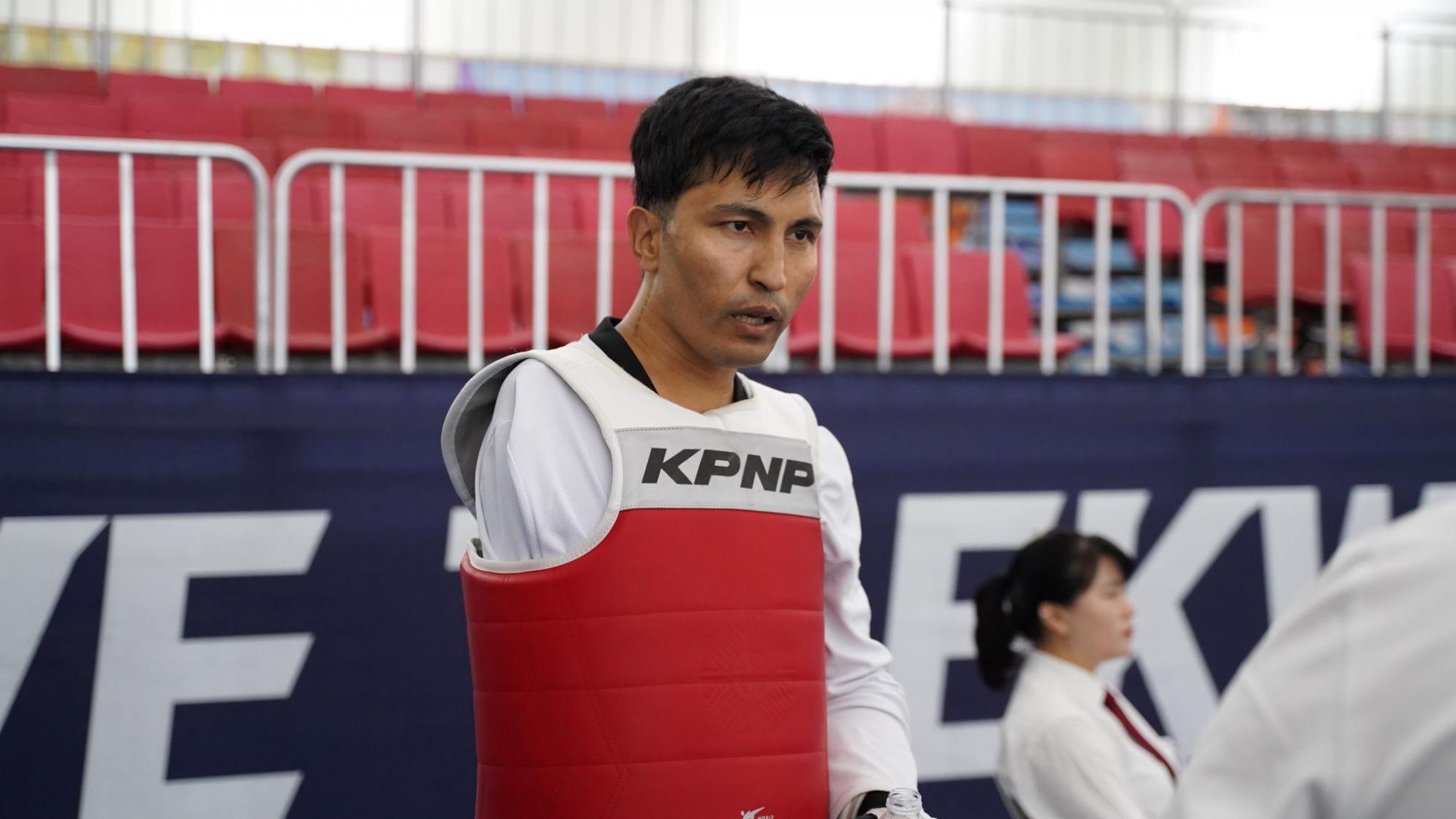 Hadi Hassanzada, a member of the Refugee Paralympic Team at Paris 2024, is photographed wearing the taekwondo gear.