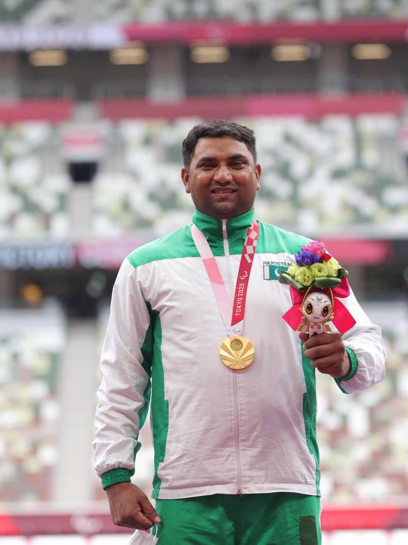 Pakistan's Haider Ali smiles on the podium with the gold medal