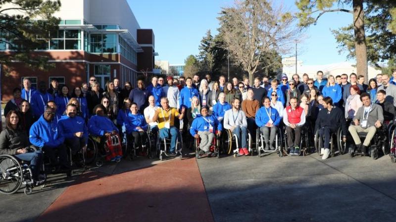 A group of about 80 people pose for a photo at the second IPC Athletes Forum, USA