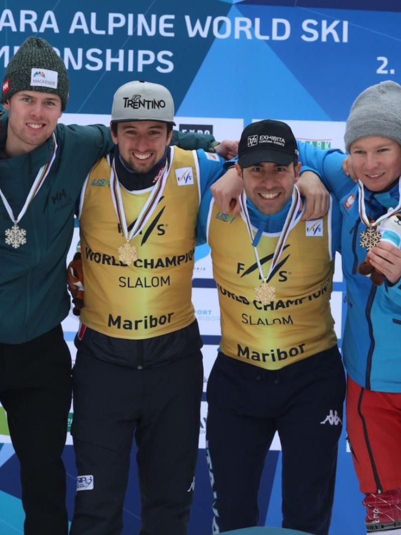 Six Para alpine skiers and guides pose for a photo on the podium