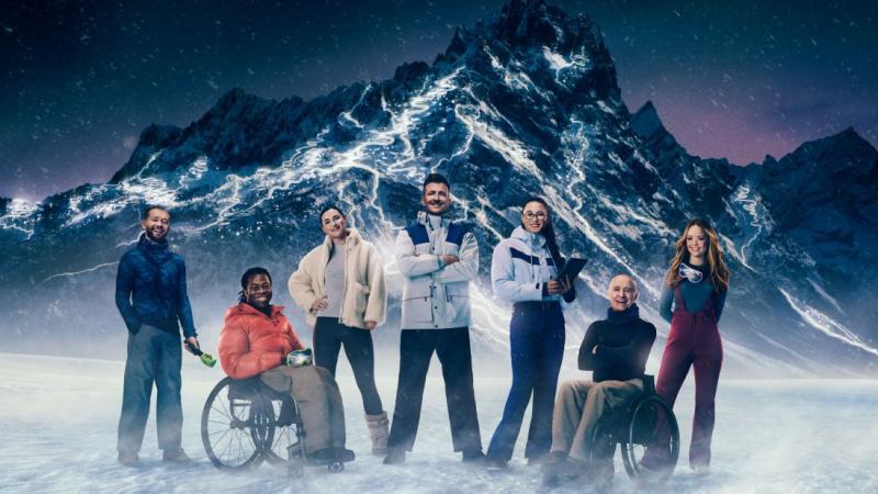 Seven people stand in front of a snowy mountain, which will host the Milano Cortina 2026 Paralympics, 