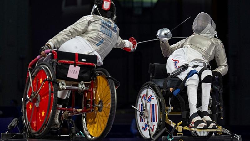 Two Para fencing athletes in action