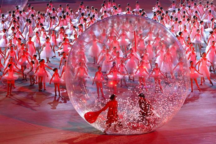 Many ballerinas are performing on stage during the Sochi 2014 Opening Ceremony