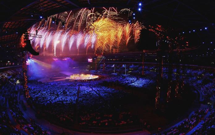 Photo of a stadium taken from the stands shows a firework display 