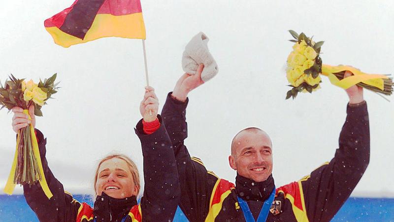 Verena Bentele celebrates on the podium with her guide at Salt Lake City 2002