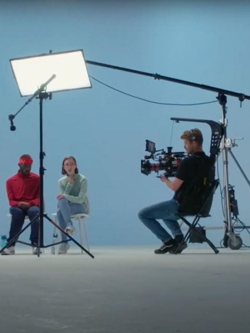 A male athlete on a wheelchair is filmed by a production crew